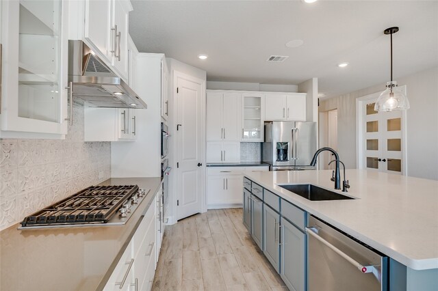 125 Serene Hilltop Cir, Austin, TX 78738 - kitchen featuring stainless steel appliances, a sink, white cabinetry, and recessed lighting