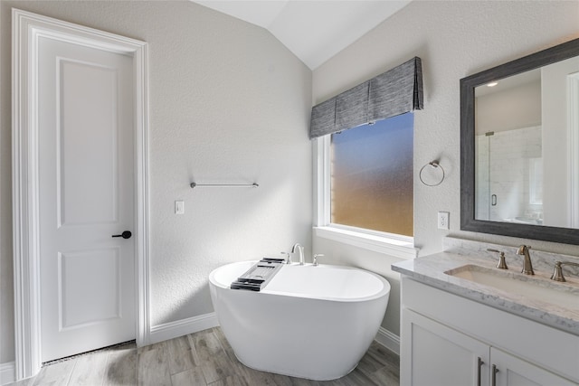 125 Serene Hilltop Cir, Austin, TX 78738 - bathroom with vanity, a soaking tub, baseboards, wood finished floors, and a textured wall