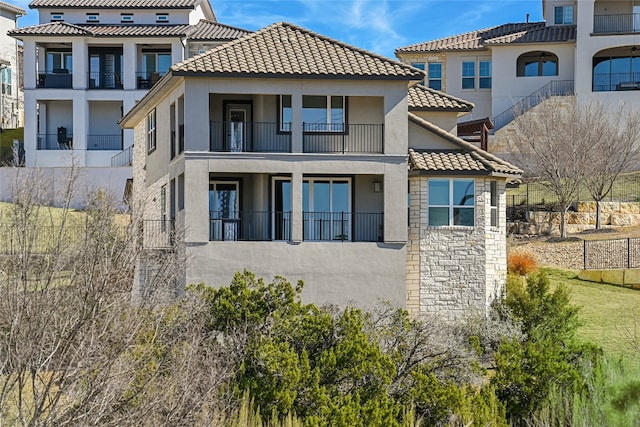 125 Serene Hilltop Cir, Austin, TX 78738 - back of property featuring a balcony, stucco siding, a tile roof, and stone siding