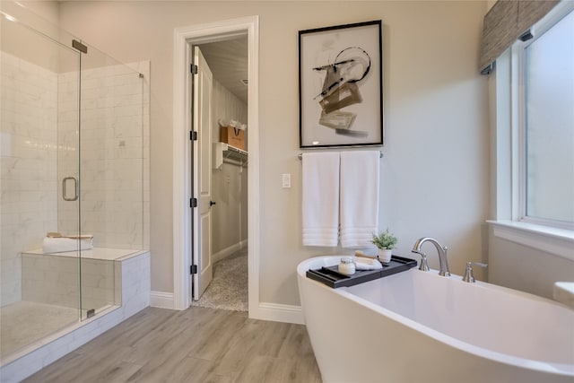 125 Serene Hilltop Cir, Austin, TX 78738 - bathroom featuring a shower stall, a soaking tub, healthy amount of natural light, and wood finished floors