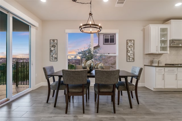 125 Serene Hilltop Cir, Austin, TX 78738 - dining area with a chandelier, recessed lighting, baseboards, and light wood finished floors