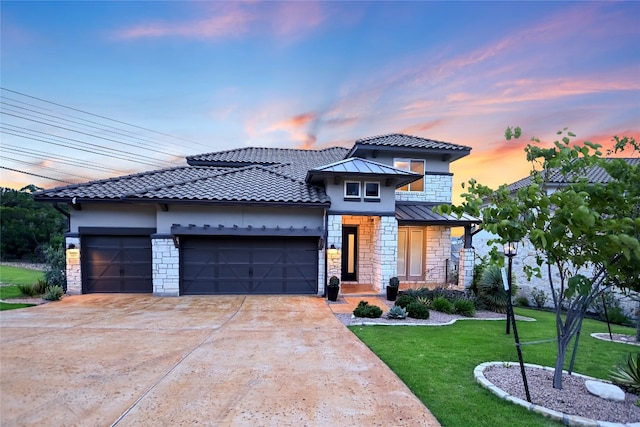 125 Serene Hilltop Cir, Austin, TX 78738 - view of front of home with stone siding, an attached garage, a front yard, driveway, and stucco siding