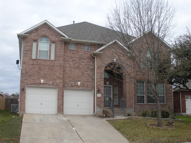 view of front facade featuring cooling unit and a garage