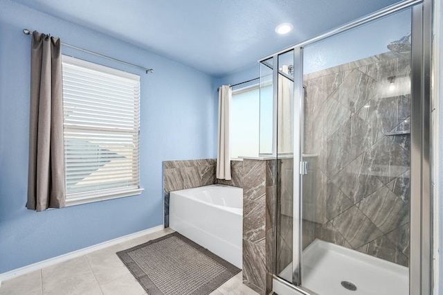 bathroom with independent shower and bath and tile patterned flooring