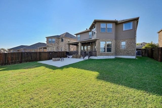 rear view of house featuring a patio, a yard, and central AC