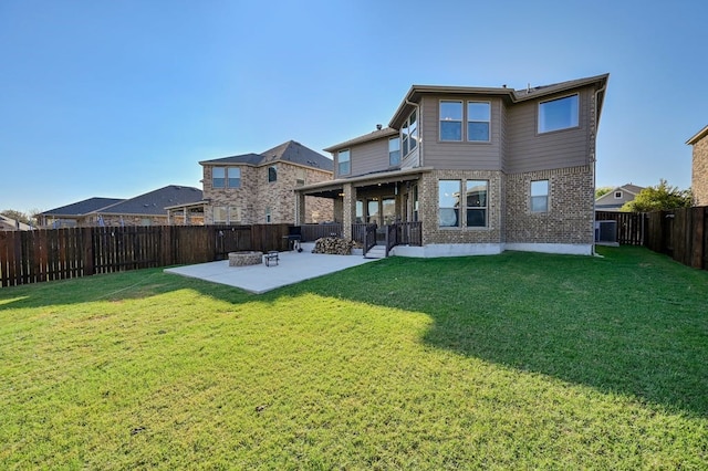 1712 Uhland Dr, Leander, TX 78641 - back of property with a patio area, brick siding, and a fenced backyard