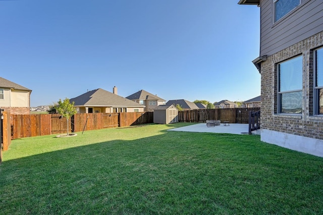 view of yard featuring a storage shed and a patio