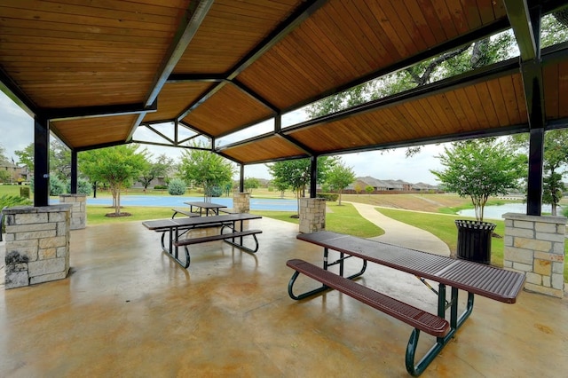 view of community featuring a lawn and a water view