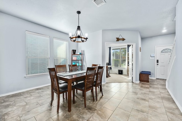 dining room with a notable chandelier