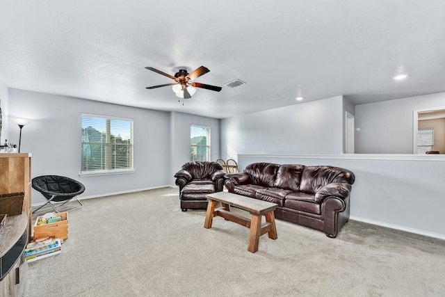 carpeted living room featuring ceiling fan