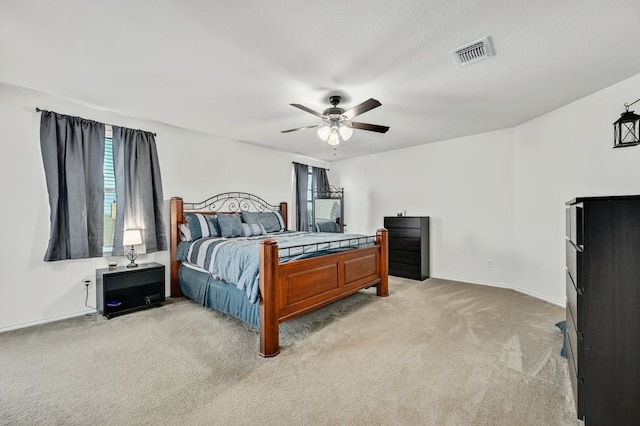 bedroom featuring light carpet and ceiling fan