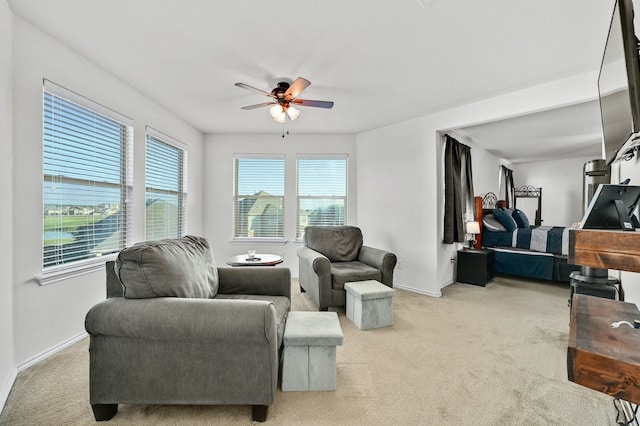 carpeted living room featuring ceiling fan