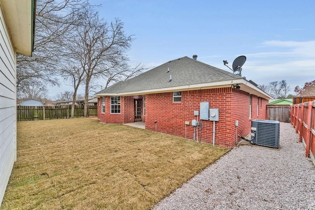 back of house featuring a yard, a patio, and central air condition unit