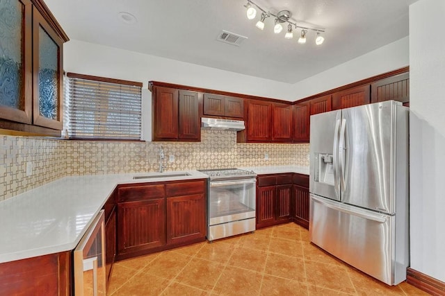 kitchen featuring tasteful backsplash, appliances with stainless steel finishes, and sink