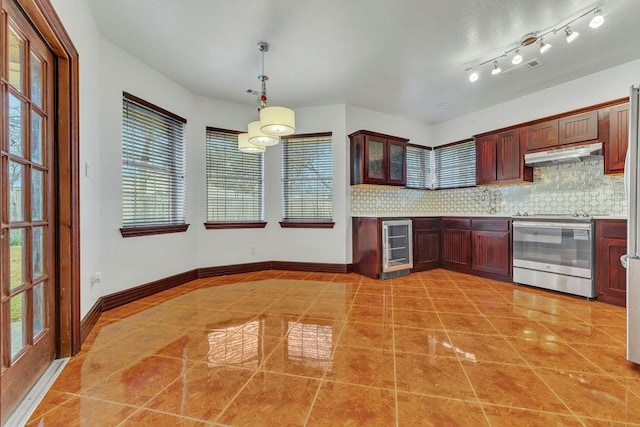 kitchen featuring decorative light fixtures, backsplash, beverage cooler, light tile patterned floors, and electric range