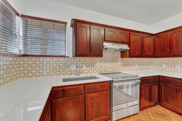 kitchen featuring light tile patterned flooring, sink, stainless steel range with electric cooktop, and decorative backsplash