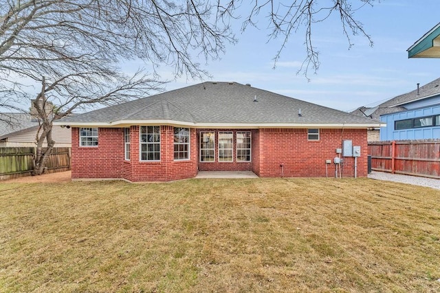 back of house featuring a patio area and a lawn