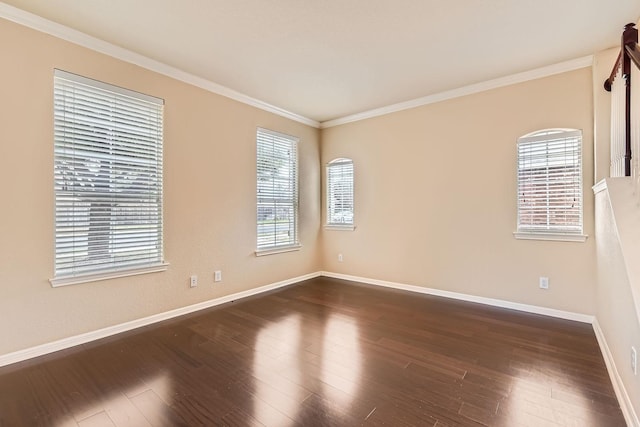 unfurnished room featuring dark wood-type flooring and ornamental molding