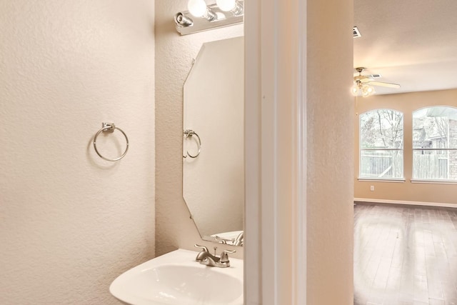 bathroom with hardwood / wood-style flooring, sink, and ceiling fan