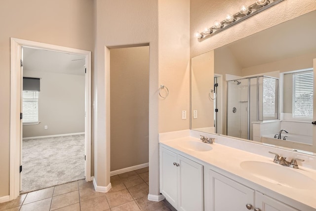 bathroom featuring a healthy amount of sunlight, tile patterned flooring, vaulted ceiling, and independent shower and bath