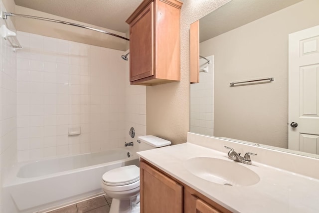 full bathroom with shower / tub combination, vanity, a textured ceiling, tile patterned floors, and toilet