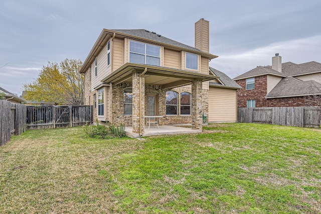 back of property with a patio and a yard