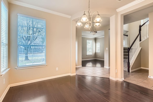 unfurnished dining area with crown molding, wood-type flooring, and a chandelier