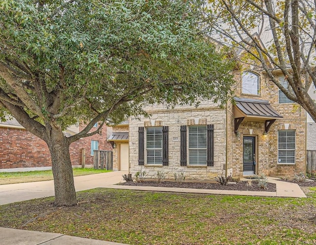 4312 Clear Meadow Pl, Round Rock, TX 78665 - view of front of property with concrete driveway, a standing seam roof, an attached garage, stone siding, and metal roof
