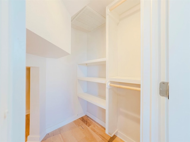 spacious closet featuring light hardwood / wood-style flooring