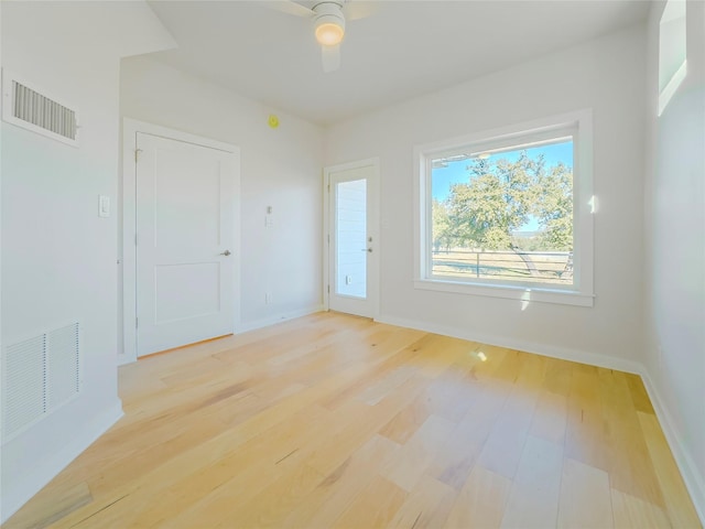 empty room with light hardwood / wood-style flooring and ceiling fan