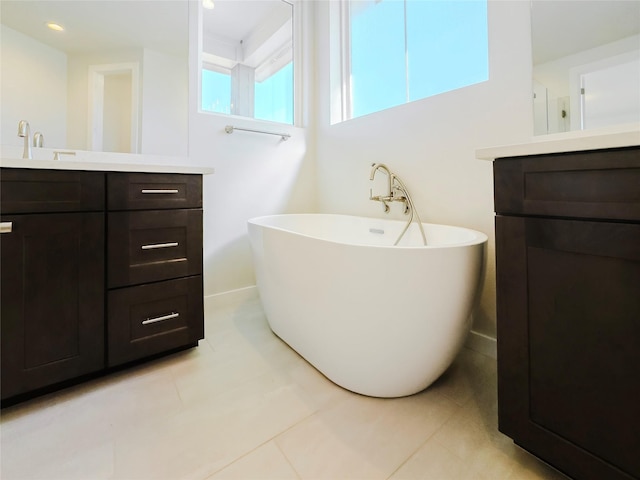 bathroom featuring vanity, a tub, and tile patterned floors