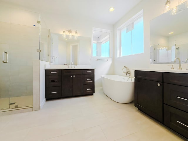 bathroom featuring vanity, tile patterned flooring, and separate shower and tub