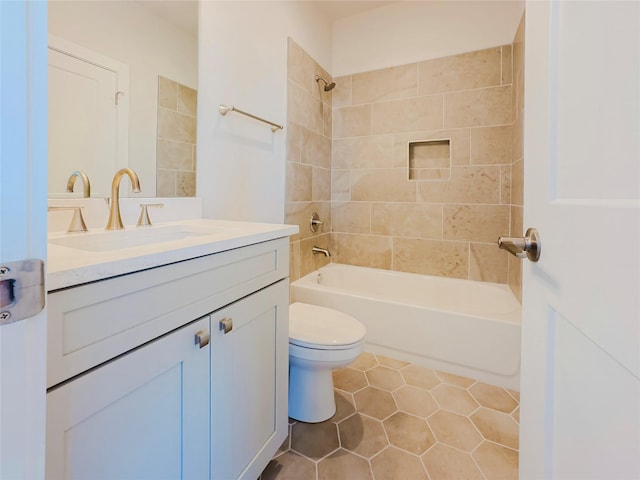 full bathroom with vanity, tiled shower / bath, tile patterned flooring, and toilet