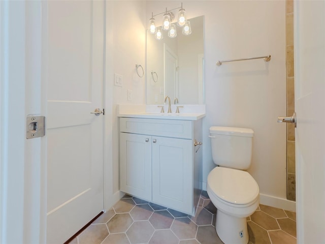 bathroom featuring vanity, toilet, and tile patterned flooring