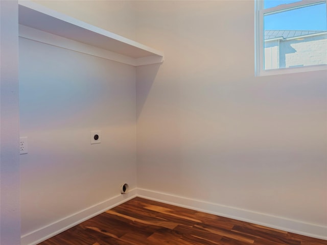 laundry area with electric dryer hookup and dark wood-type flooring