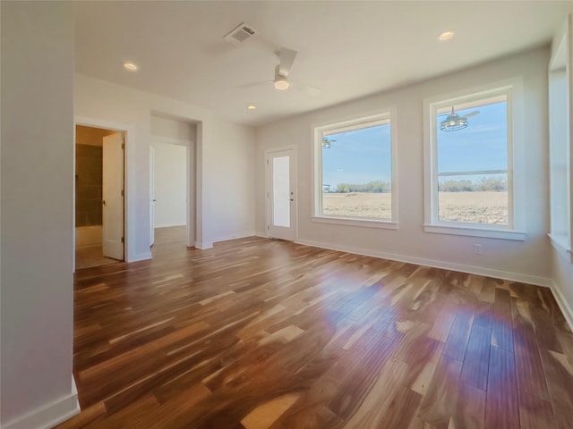 spare room with hardwood / wood-style flooring and ceiling fan