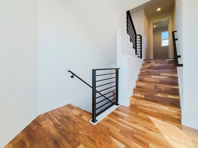 staircase with hardwood / wood-style flooring