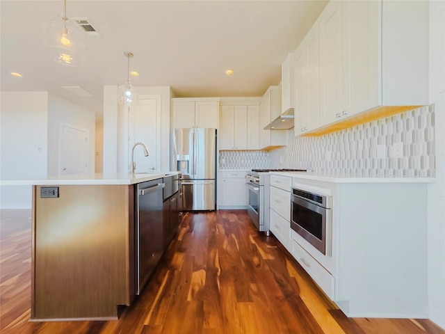 kitchen with white cabinetry, appliances with stainless steel finishes, dark wood-type flooring, and tasteful backsplash