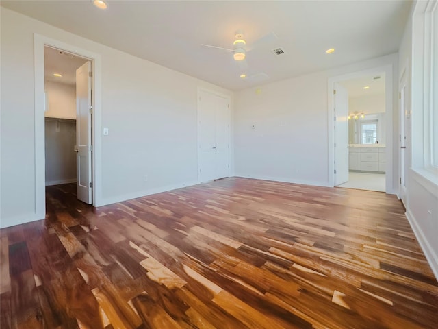 unfurnished room with ceiling fan and dark hardwood / wood-style flooring