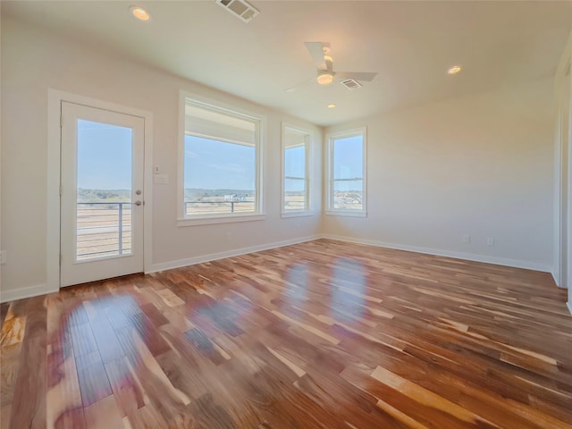 unfurnished room with hardwood / wood-style flooring and ceiling fan