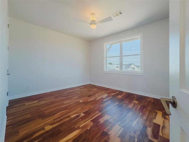 empty room featuring ceiling fan and dark hardwood / wood-style flooring