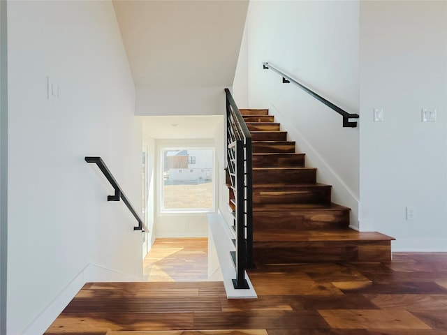 stairway with hardwood / wood-style floors