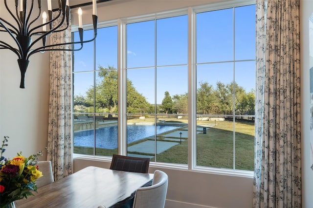 unfurnished dining area featuring a water view and a notable chandelier