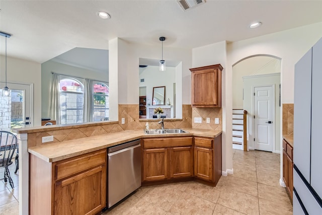 kitchen featuring hanging light fixtures, kitchen peninsula, sink, and dishwasher