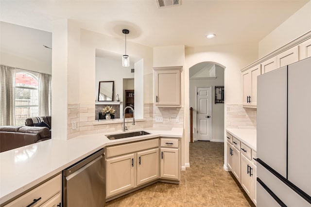 kitchen with pendant lighting, sink, dishwasher, white refrigerator, and decorative backsplash