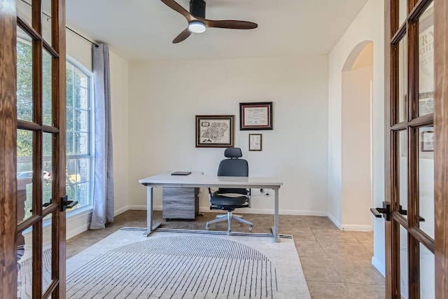 office area with french doors, ceiling fan, a healthy amount of sunlight, and light tile patterned floors