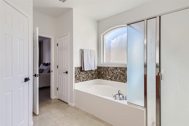 bathroom featuring tile patterned flooring and a bathing tub