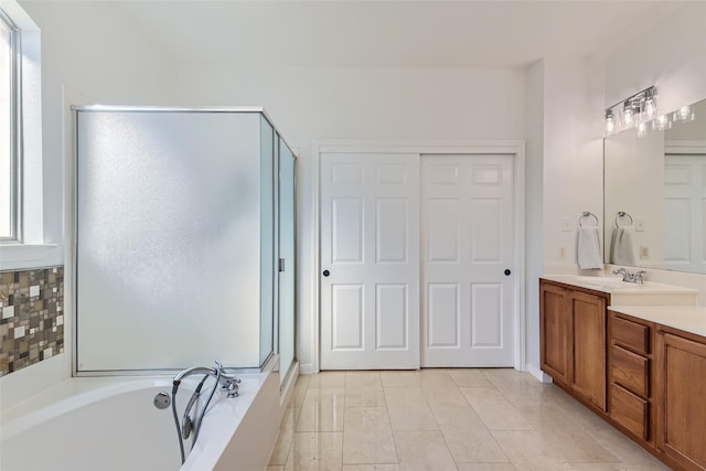 bathroom featuring vanity, shower with separate bathtub, and tile patterned flooring