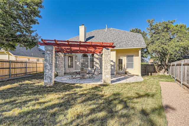 rear view of house featuring a yard, a pergola, and a patio area