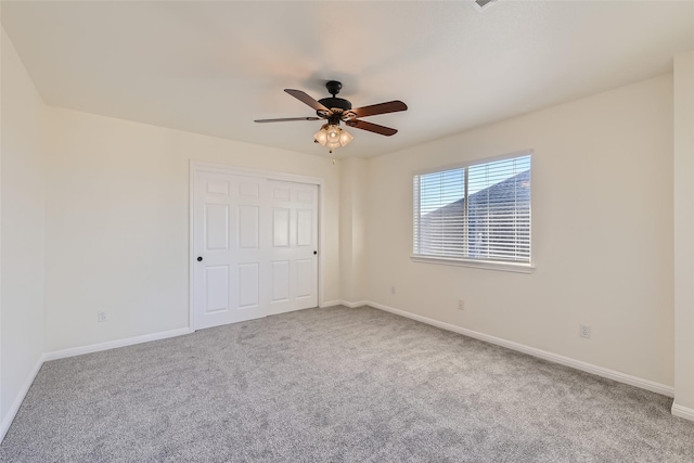 unfurnished bedroom featuring a closet, ceiling fan, and carpet